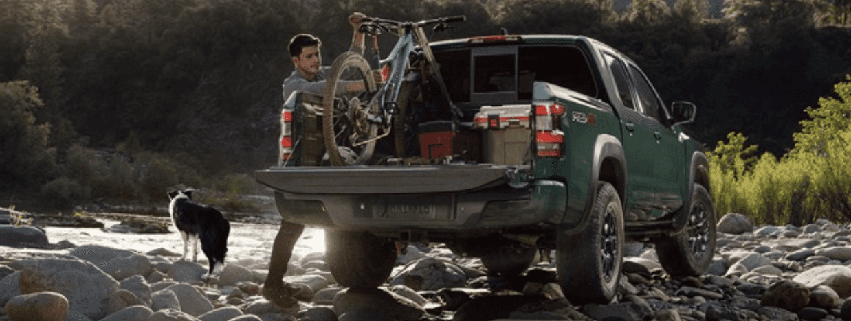 Man taking the dependable 2023 Nissan Frontier out on the trails.