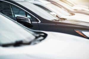 A row of pre-owned vehicles at a dealership.