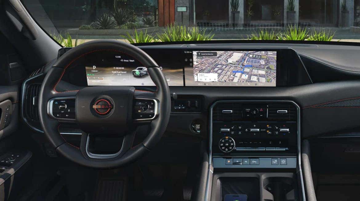 An interior of the 2025 Nissan Armada, showcasing the wheel, dash, and console.