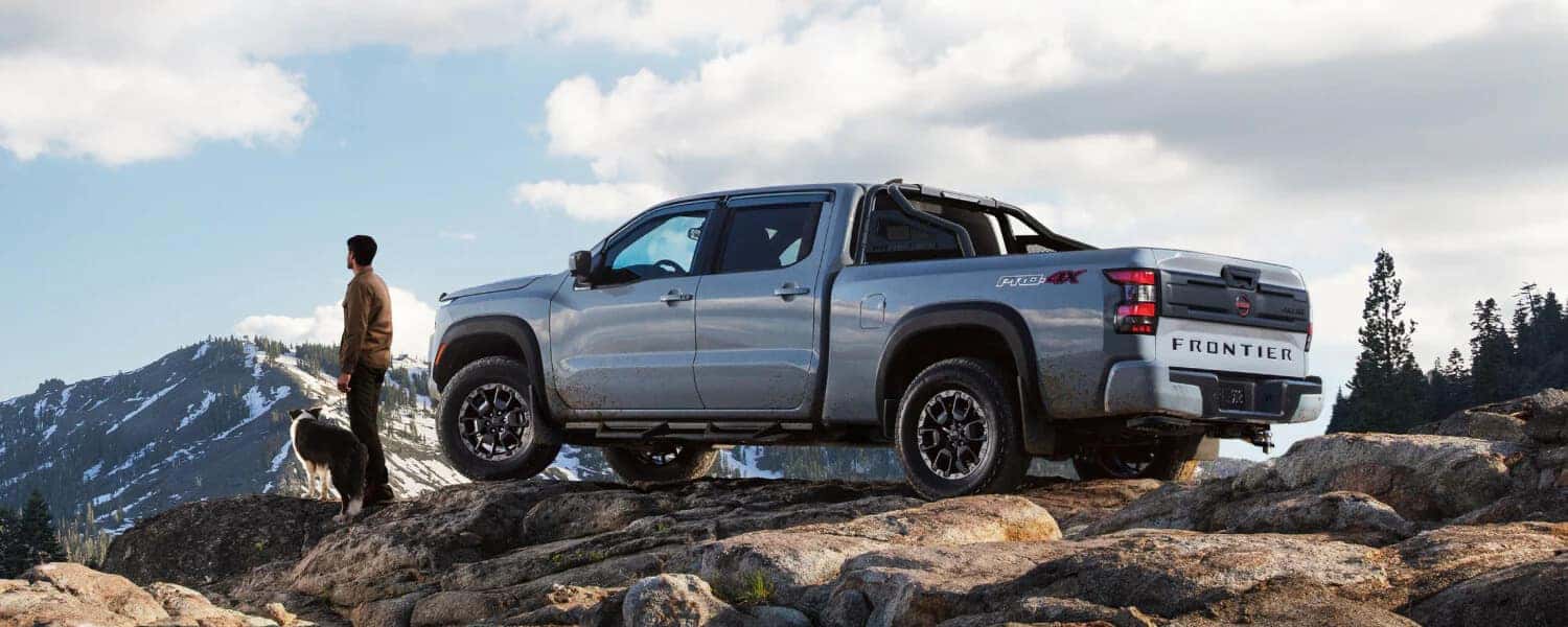 A Nissan Frontier parked on a beautiful mountain ridge.