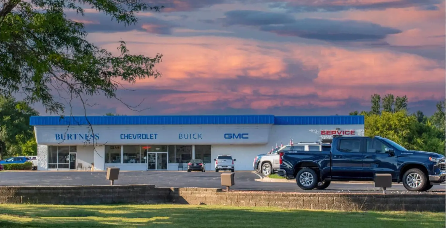 An exterior shot of a Chevrolet dealership at night.