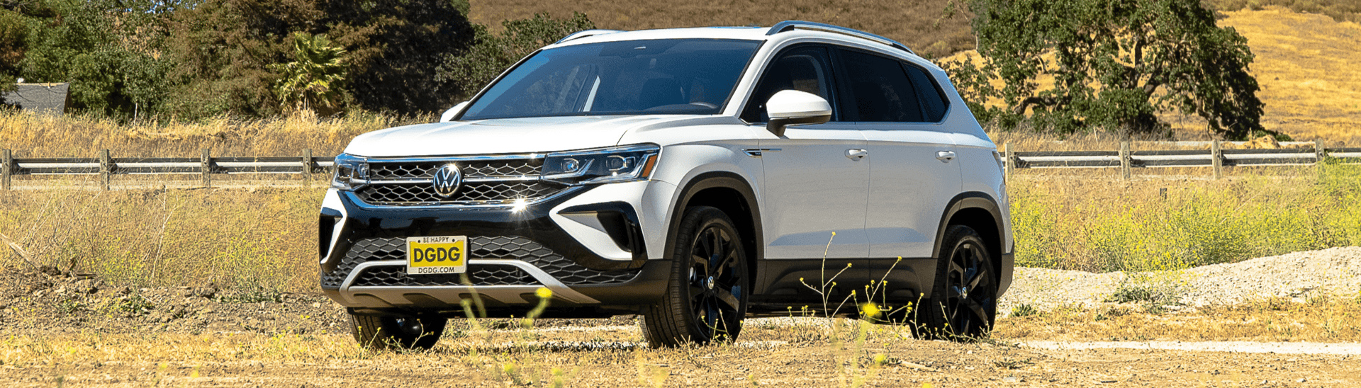 2022 Volkswagen Taos SEL in the color Pure white parked in a grass field.