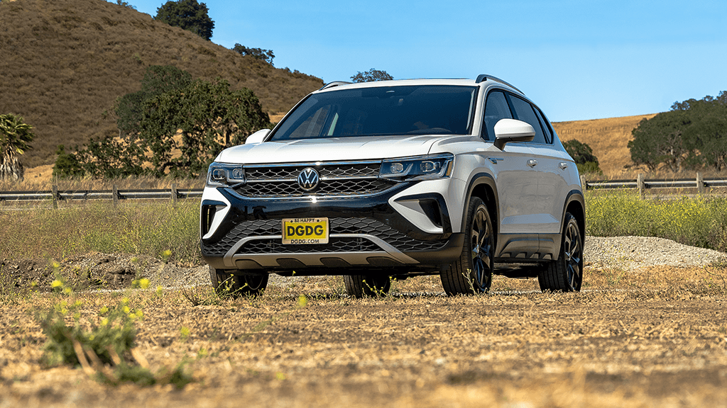 2022 Volkswagen Taos SEL in the color Pure White parked in a grass field.