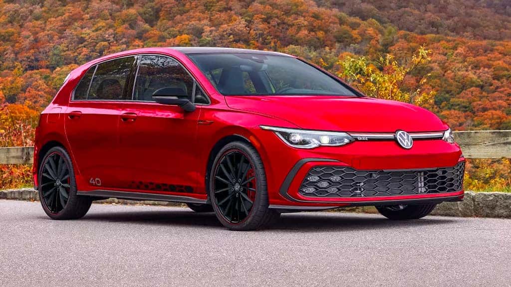 2023 Volkswagen Golf GTI parked on the side of a road.