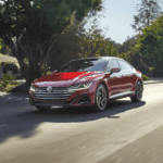 2022 Volkswagen Arteon driving along a shaded road