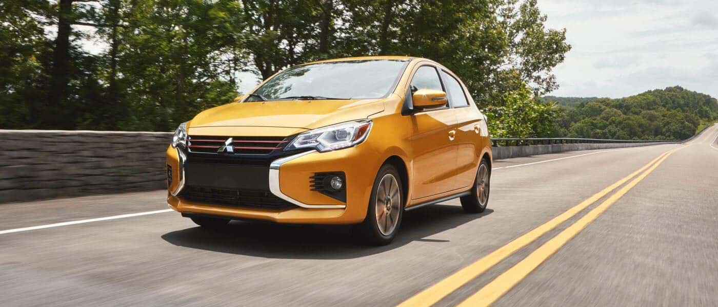 Yellow Mitsubishi SUV on a country road
