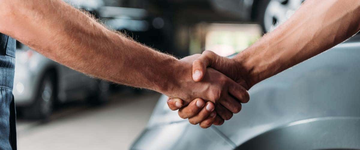 two different arms shaking hands