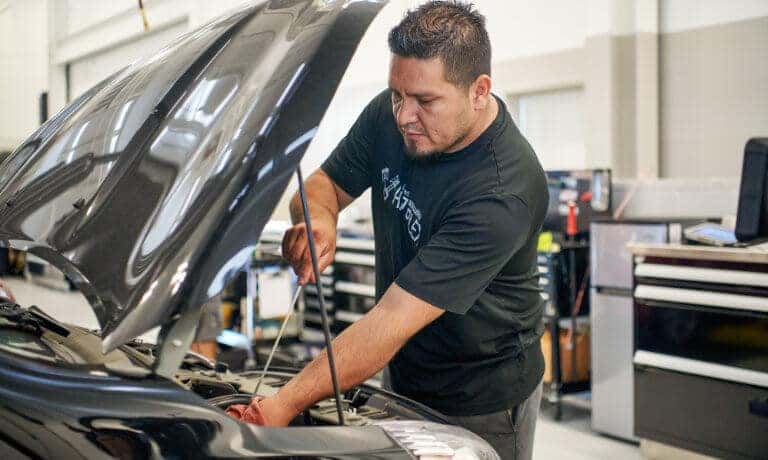 Mitsubishi technician checking oil