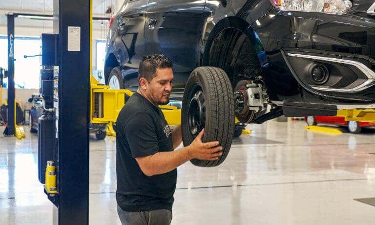 Mitsubishi technician changing tire