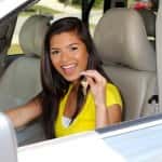 Teen holding up keys to her new car