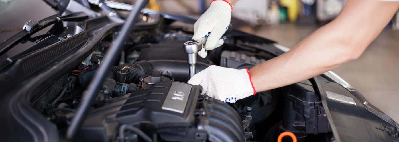 hands of mechanic under hood