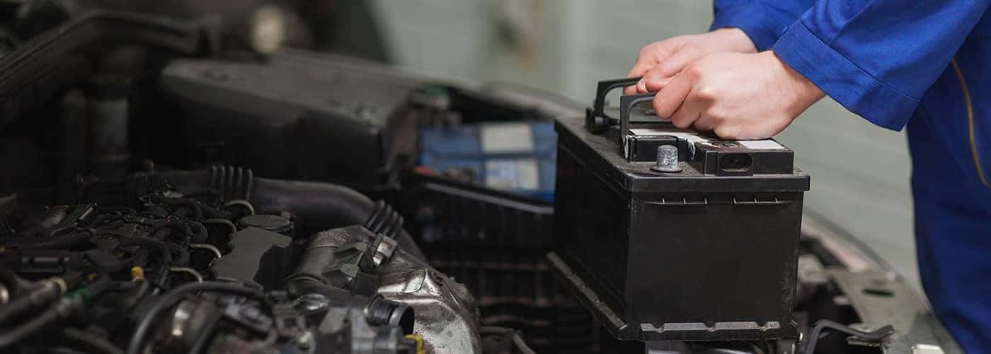 Mechanic replacing car battery