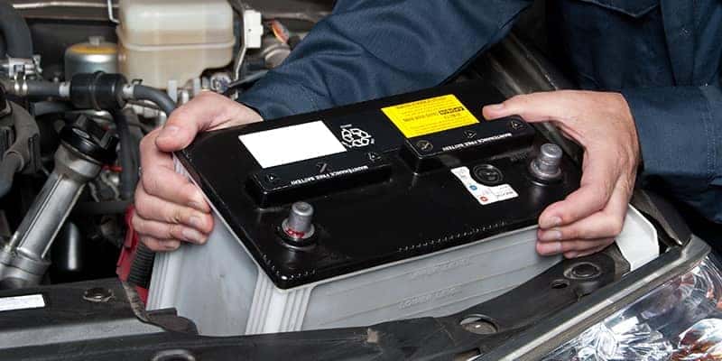 Mechanic replacing car battery