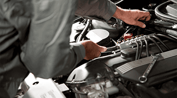 Mechanic's hands under hood