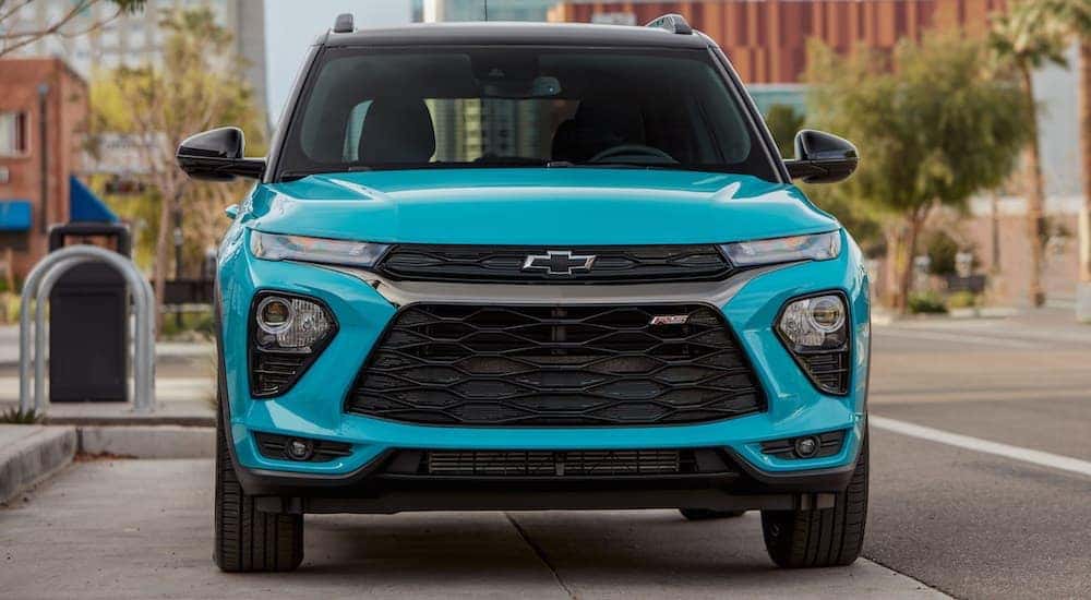 Front view of a teal 2021 Chevy Trailblazer parked on a city street.