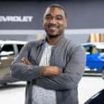 A smiling man standing in the showroom of an Alabama Chevy dealership.