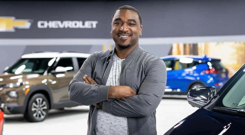 A smiling man standing in the showroom of an Alabama Chevy dealership.