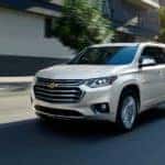 A white 2021 Chevy Traverse driving down the road.