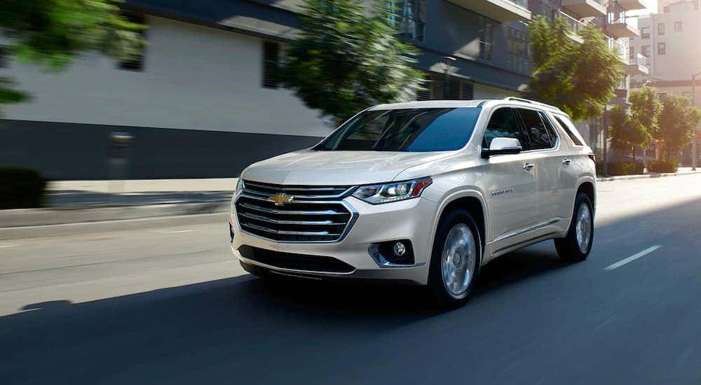 A white 2021 Chevy Traverse driving down the road.