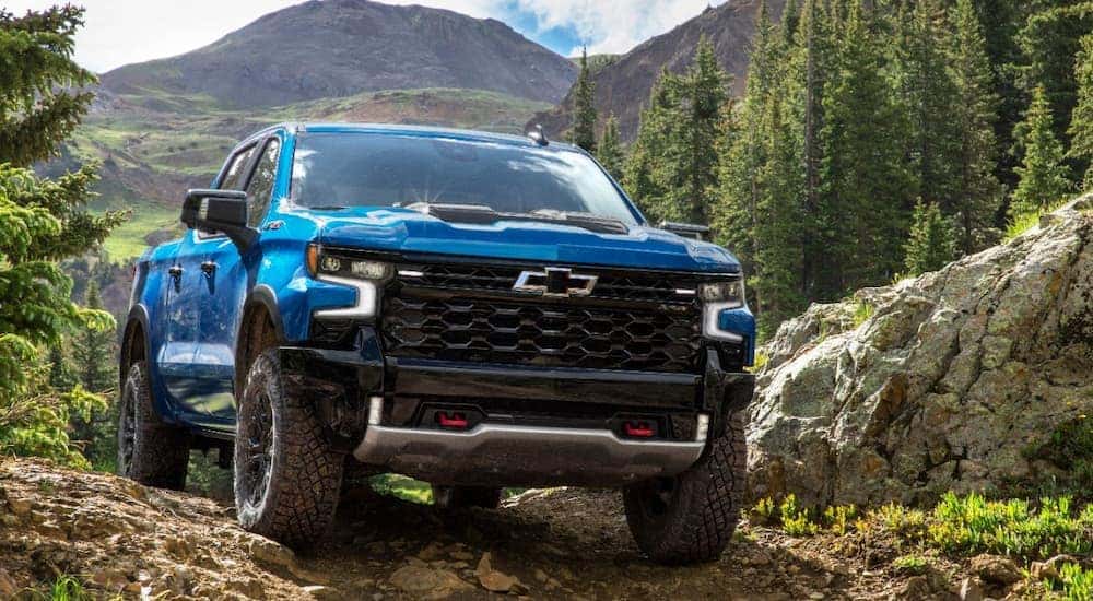 A blue Chevy Silverado ZR2 off-roading in the mountains.