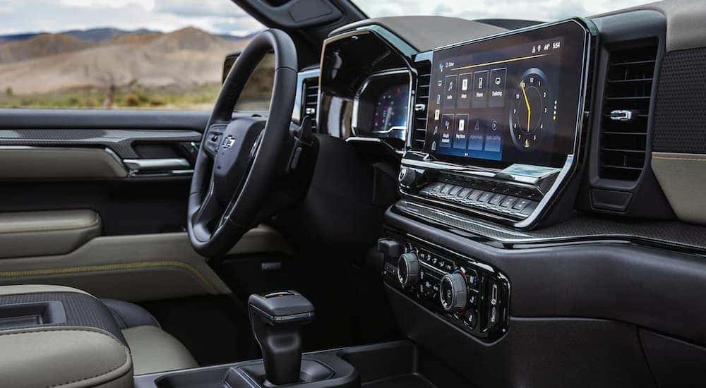 Interior view of the steering wheel and infotainment screen in a 2022 Chevy Silverado ZR2 for sale at a Chevy Silverado dealership.