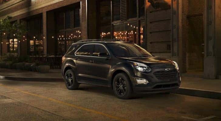 A black 2017 Chevy Equinox is shown on a city street after leaving a used Chevy SUV dealer near you.