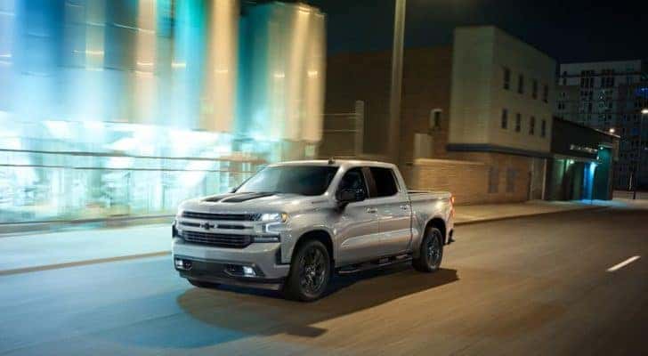 A silver 2020 Chevy Silverado 1500 is shown from the front at an angle.