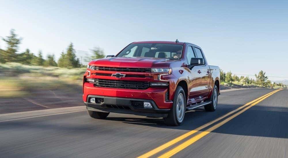 Front-view of a red 2020 Chevy Silverado 1500 driving on an open highway