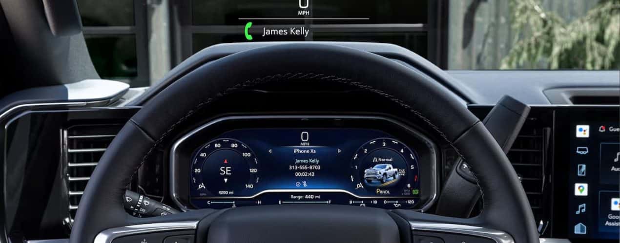 The dashboard and steering wheel in a 2024 Chevy Silverado 2500 HD is shown.