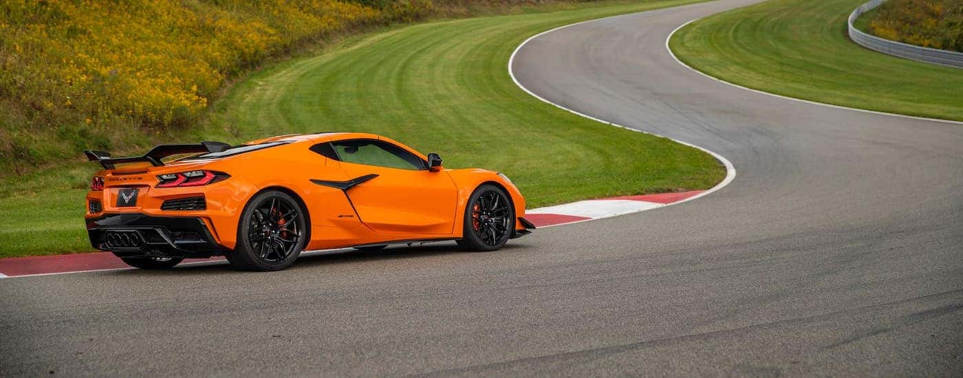 An orange 2023 Chevy Corvette Z06 is shown on a racetrack after leaving a Huntsville Chevy dealer.