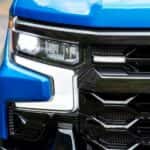 A close up of the passenger side headlight on a a blue 2023 Chevy Silverado ZR2.