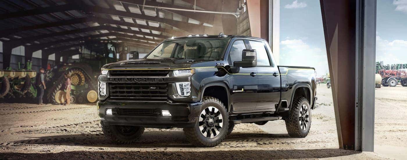 A black 2021 Chevy Silverado 2500 HD Carhartt Edition is shown from the front at an angle after leaving an Arab Chevy truck dealer.