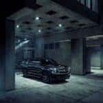 A black 2018 Chevy Tahoe Midnight parked in a concrete gallery with moody lighting