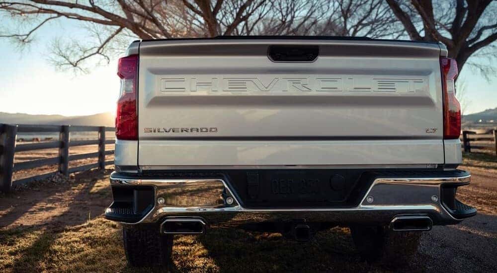 The closed tailgate of a silver 2023 Chevy Silverado 1500 LT is shown.