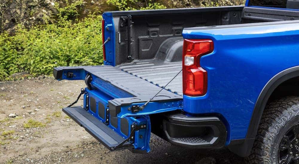 A blue 2024 Chevy Silverado 1500 ZR2 is shown from the rear in close-up.