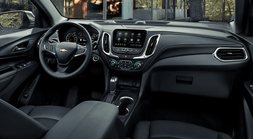 The black interior and dashboard of a 2021 Chevy Equinox is shown.