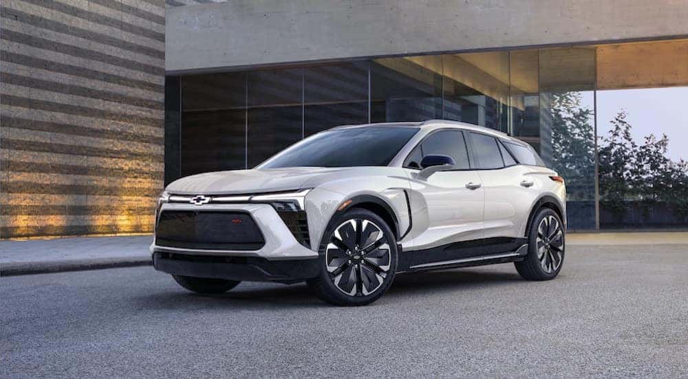 A white 2024 Chevy Blazer EV is shown parked near a building.