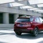 A red 2024 Chevy Equinox is shown driving in a tunnel.