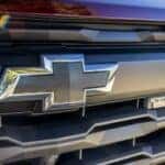 A close up shows the grille and badging on a red 2024 Chevy Colorado Trail Boss.