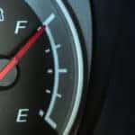 Vehicle fuel gauge with the red ticker pointing toward "F"