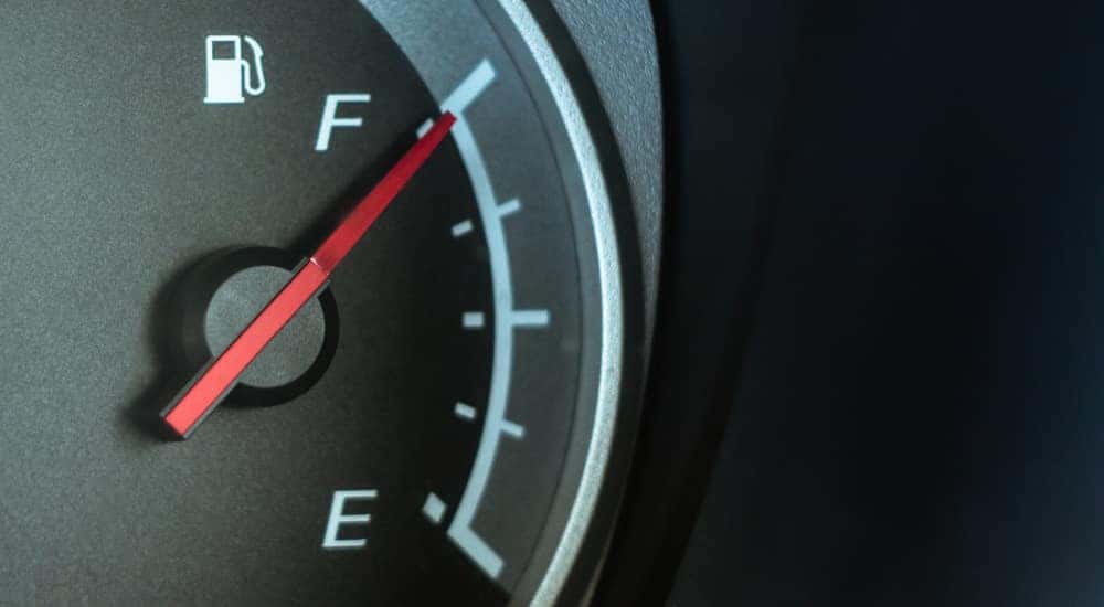 Vehicle fuel gauge with the red ticker pointing toward "F"