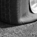 Close-up of a flat tire on the pavement