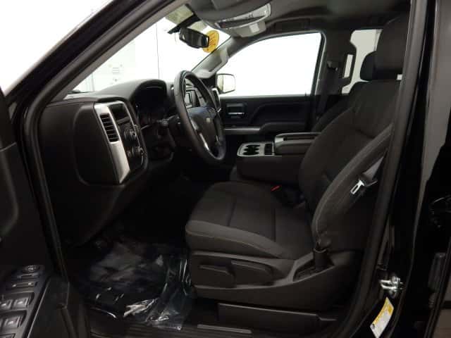 Side view of a 2014 Chevy Silverado LT interior through the drivers side door