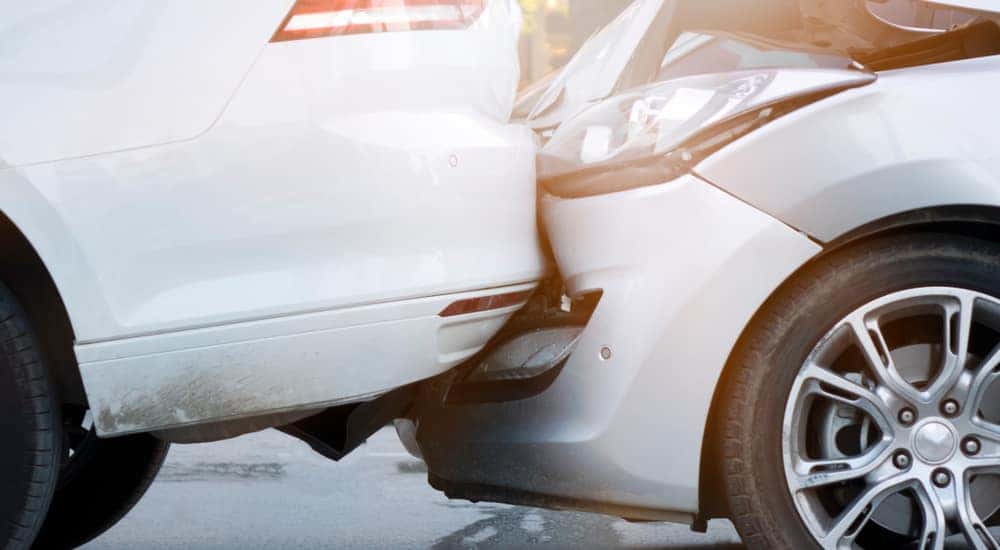 Close-up of a white vehicle rear-ending another white vehicle