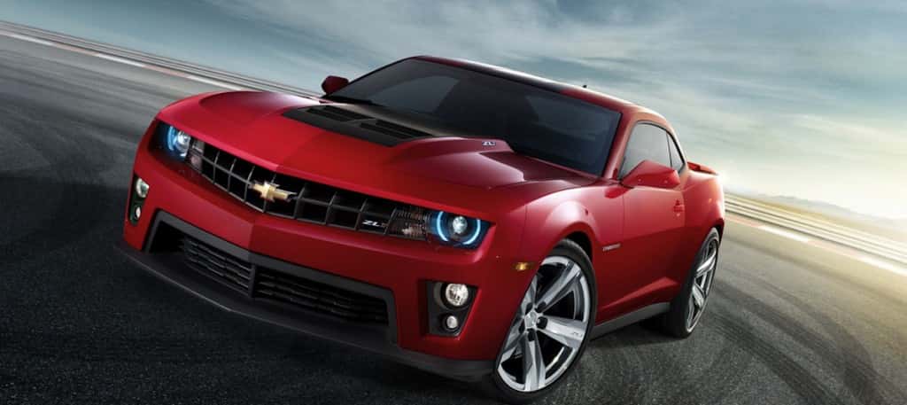 Front view of a red 2012 Chevrolet Camaro ZL1 doing a burnout