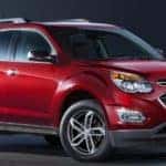 Red 2016 Chevrolet Equinox against a black background