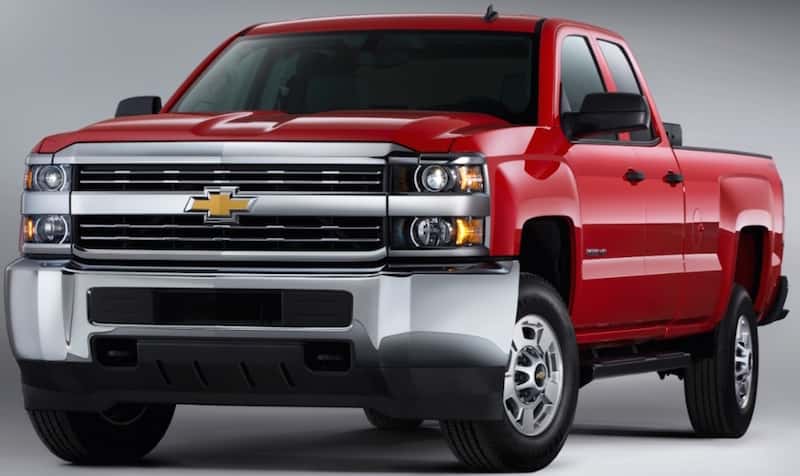 Front view of a red 2016 Chevrolet Silverado in an all grey room