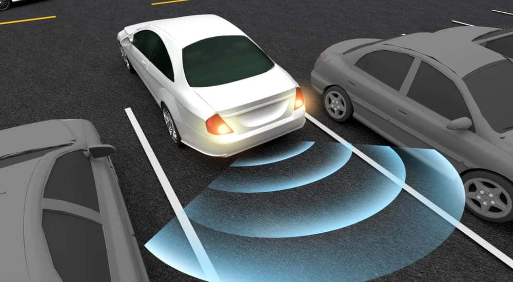 Cartoon of a white car with blue lights coming out of the back to represent rear back-up assist