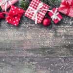 Small red and white gift boxes on a light grey table
