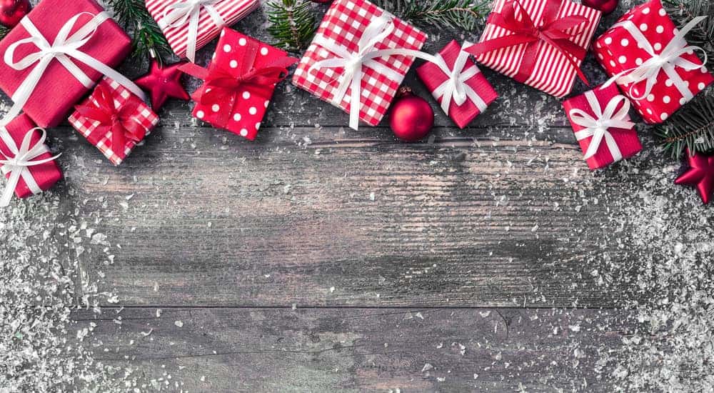Small red and white gift boxes on a light grey table
